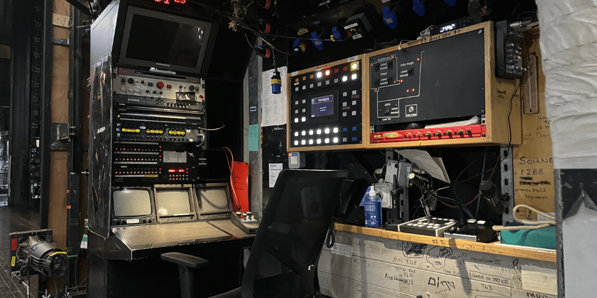 A well-equipped technical control station with various monitors and audio equipment.